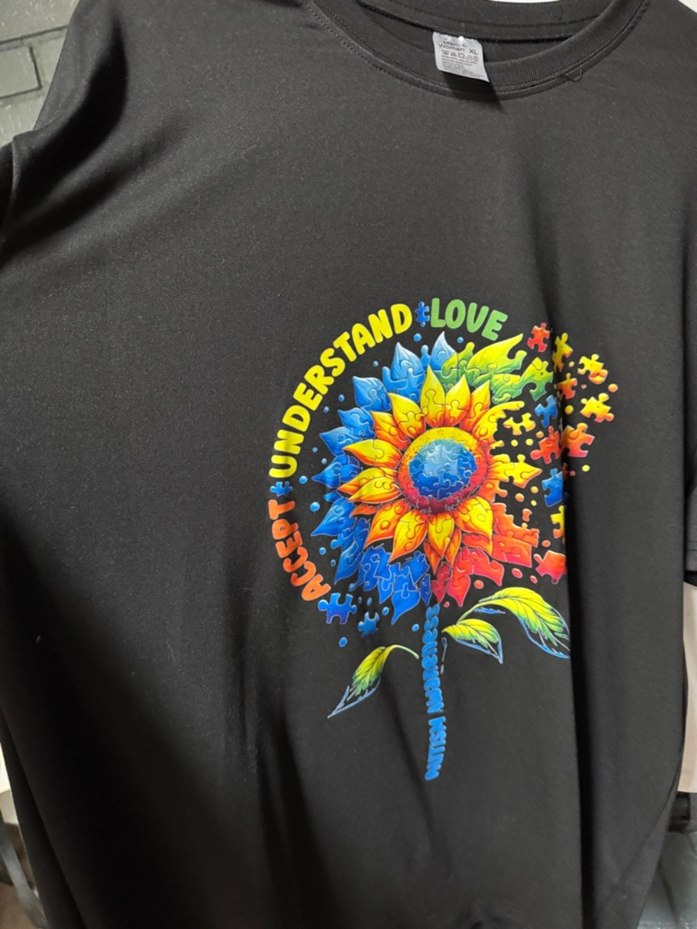 Black Graphic Tee with Colorful Sunflower Puzzle Design